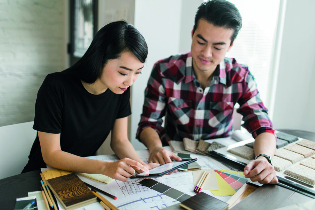 A young couple reviews floorplan on a tablet | Aluminium Composite Doors