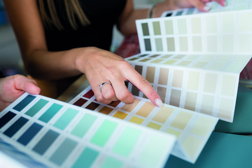 Close-up of two women choosing samples of wall paint Interior d | Aluminium Composite Doors