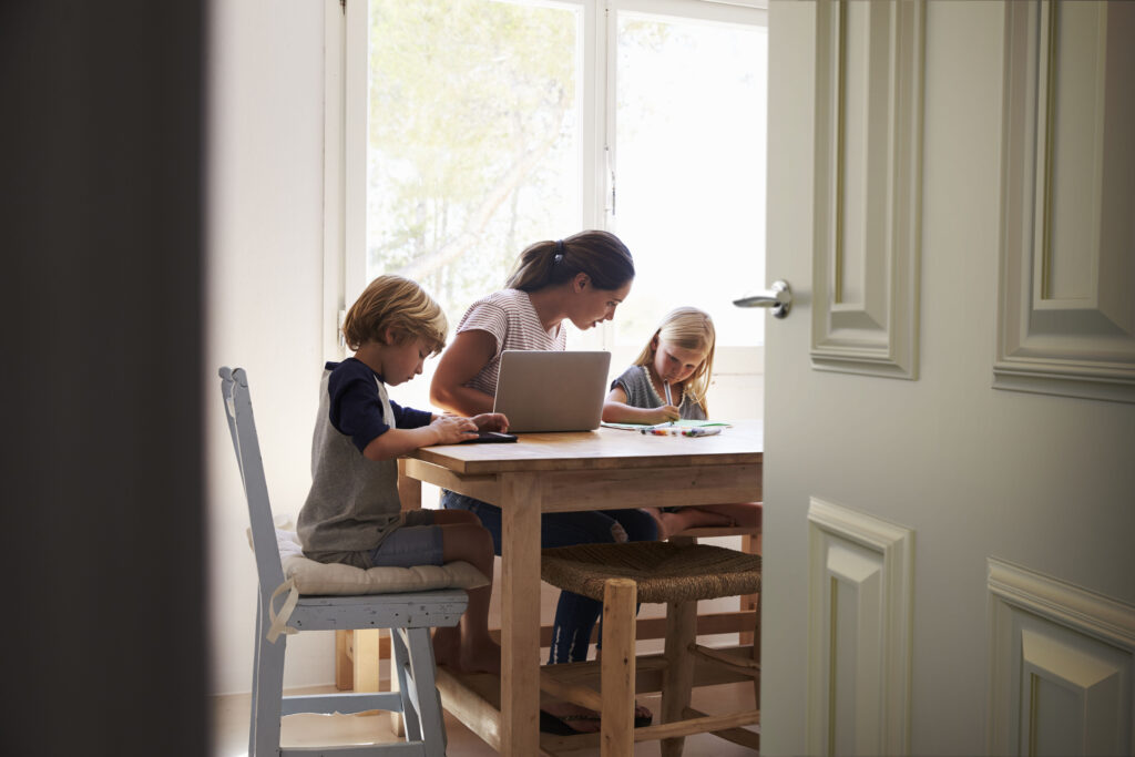 Mum and two kids working in kitchen close up from doorway | Aluminium Composite Doors