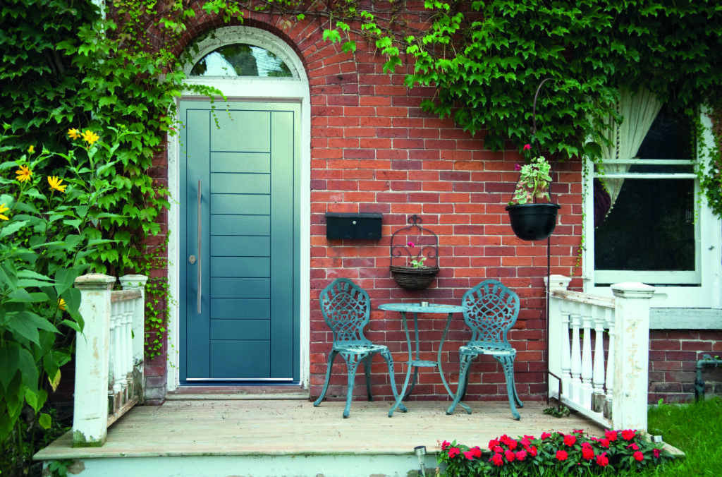 Red outside door with a patio and seating | Aluminium Composite Doors Smart aluminium composite doors like this premium aluminium composite door from GFD Homes offer cutting-edge style, strength, and value for UK homeowners